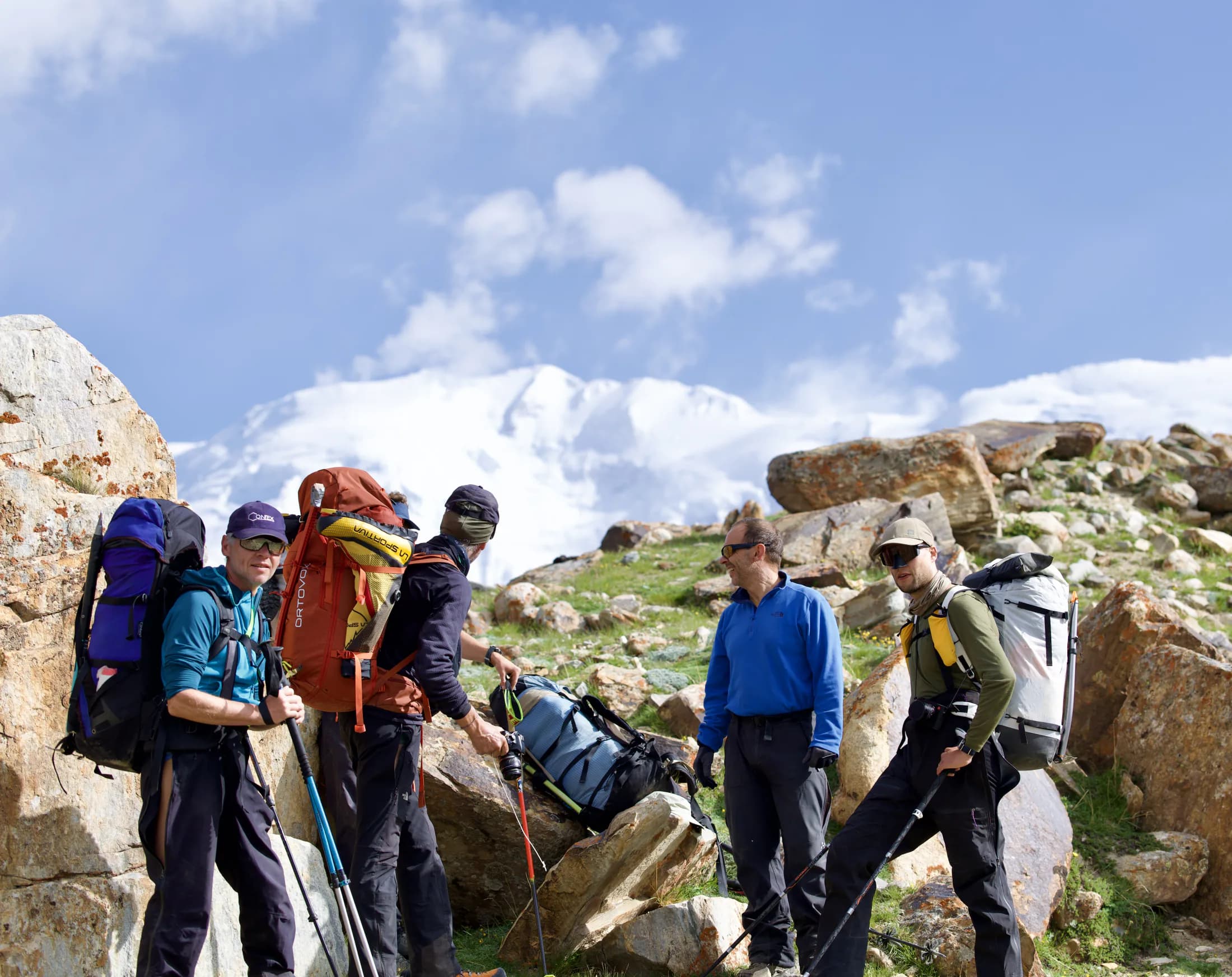 An expedition team checking equipment below Muztagh Ata