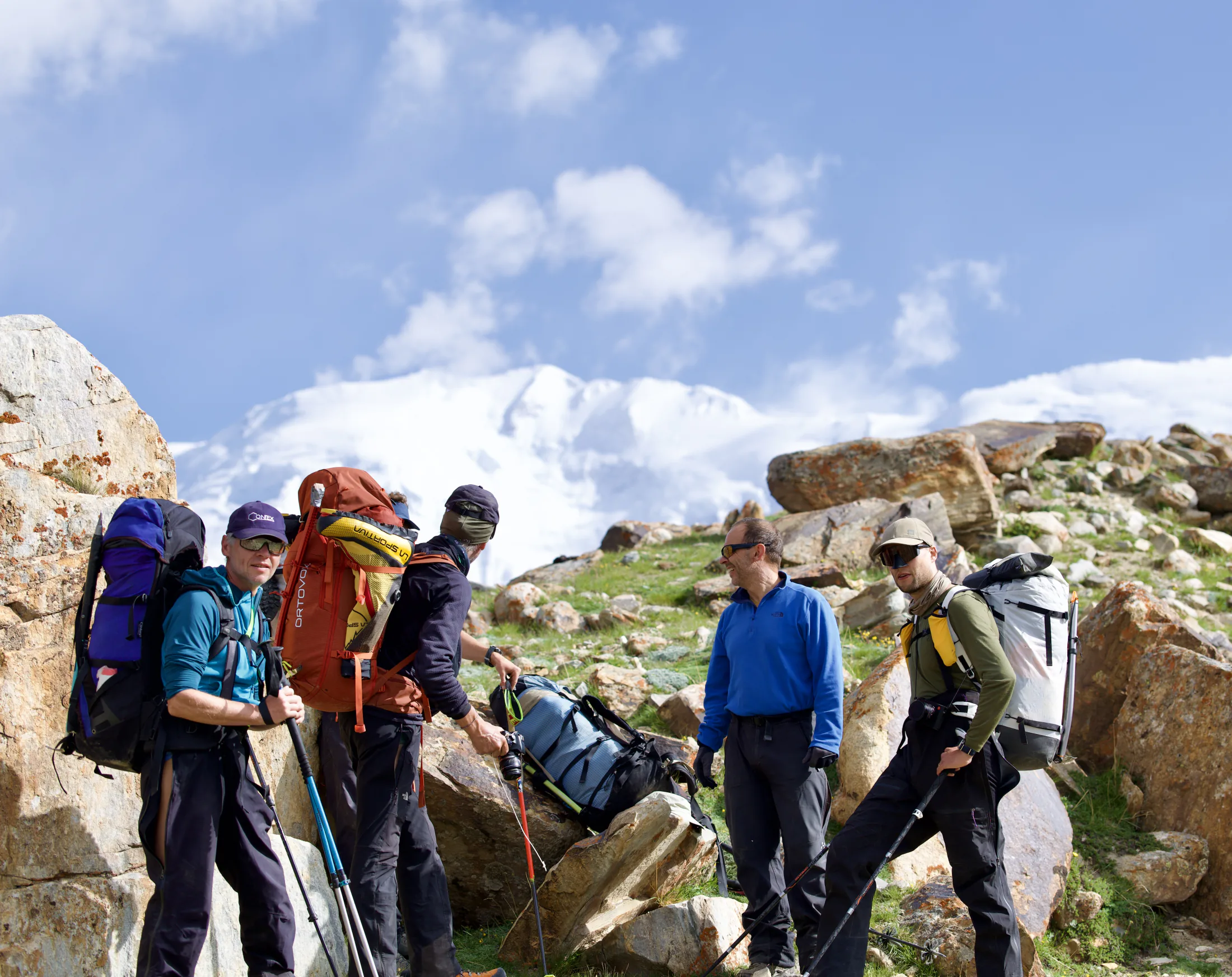 An expedition team checking equipment below Muztagh Ata