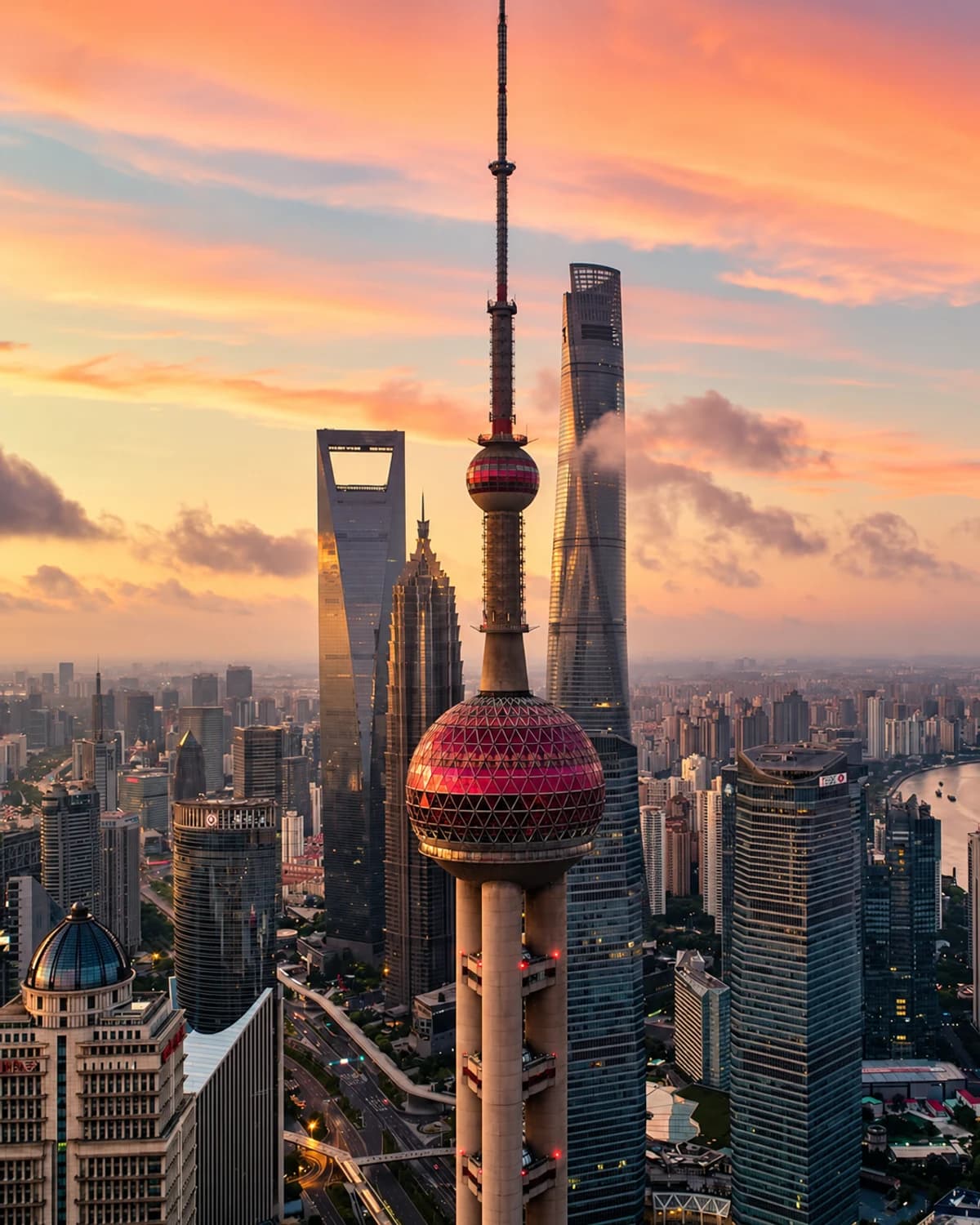 Close vertical view of the Oriental Pearl Tower framed by Lujiazui skyscrapers.