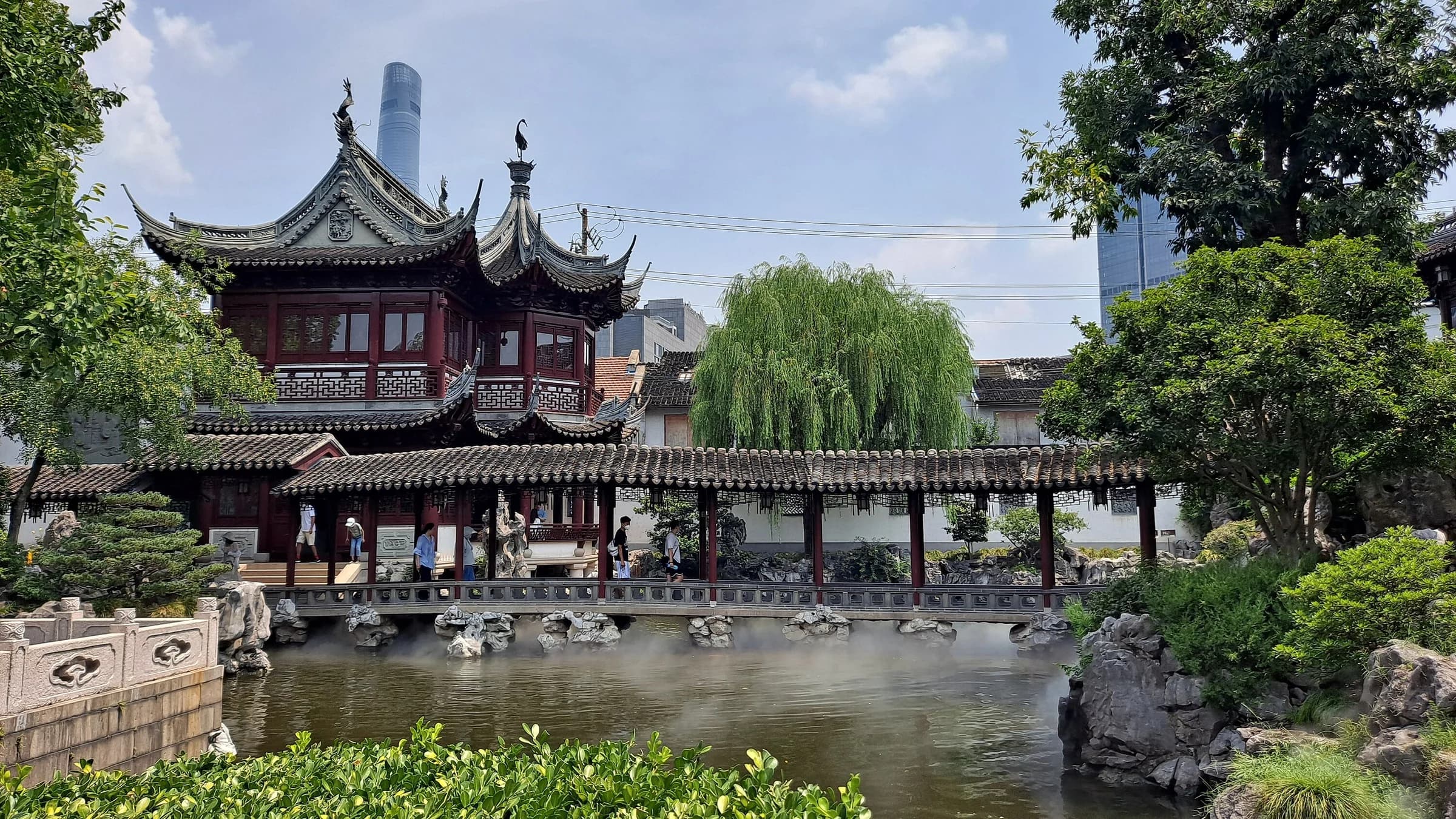 Wide view of Yu Garden's traditional buildings and water.